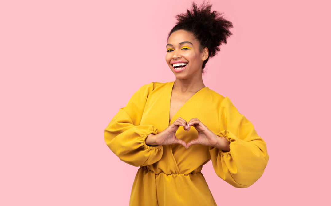 woman with a heart hand sign