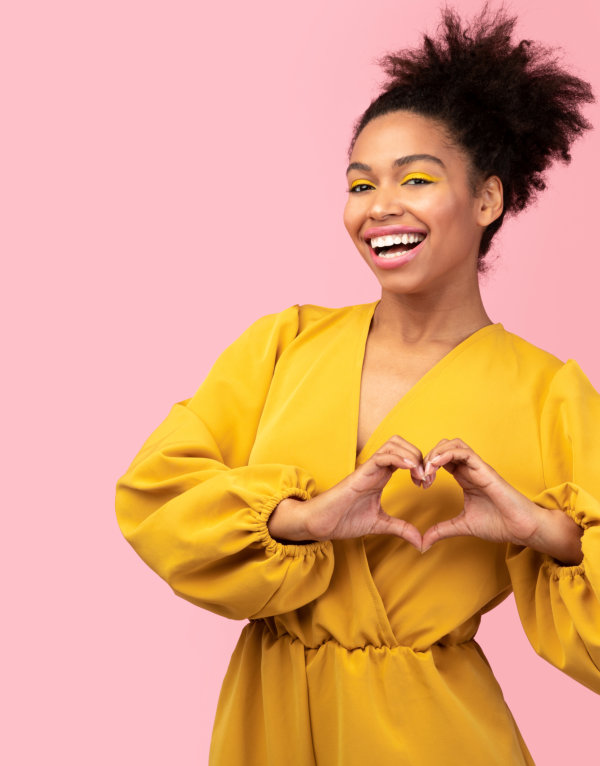 woman with a heart hand sign