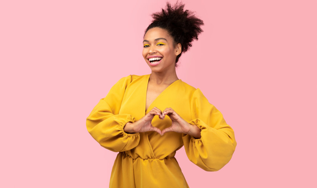 woman with a heart hand sign